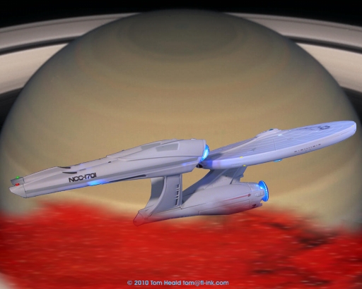 The ATL (Alternative Time Line) Enterprise rises above Saturn's moon Titan to ambush the Romulan ship Narada.  Click to see an Enlarged (512 by 410 pixels) view.