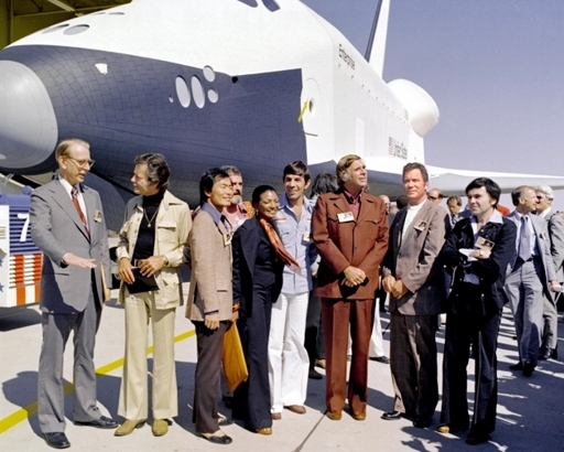 In 1976, NASA's space shuttle Enterprise rolled out of the Palmdale, CA manufacturing facilities and was greeted 
by NASA officials and cast members from the 'Star Trek' television series.